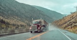 red and white truck on road during daytime