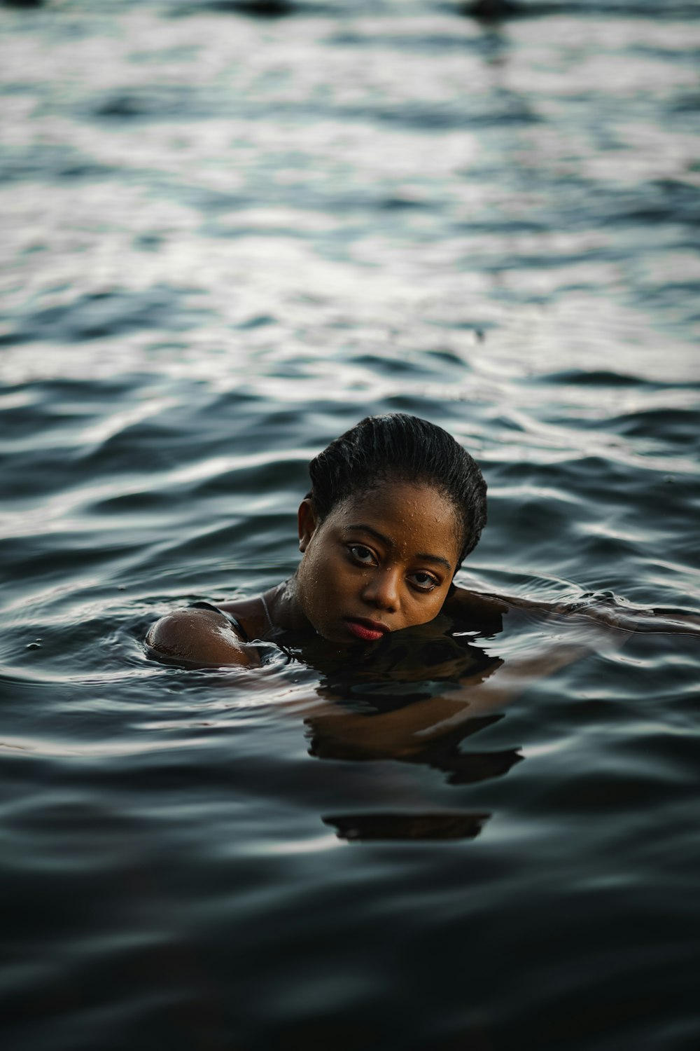 girl swimming on water during daytime