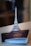 A small, detailed model of the Eiffel Tower stands on a surface, slightly in front of two open passports that are partially overlapping each other.