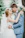 Smiling bride and groom embracing at a beautifully decorated outdoor wedding venue.