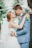 Smiling bride and groom embracing at a beautifully decorated outdoor wedding venue.