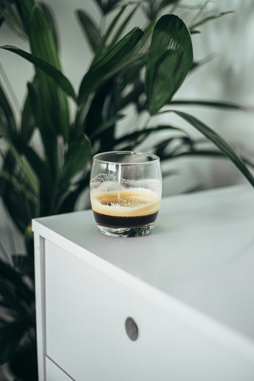 clear drinking glass with brown liquid inside