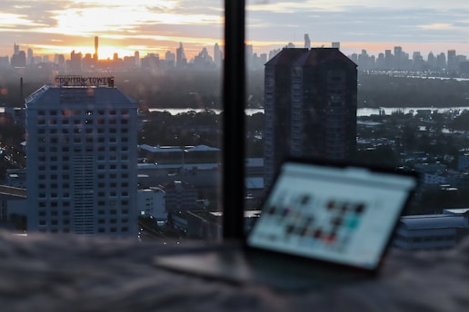 white and black high rise buildings during sunset