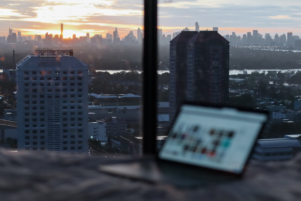 white and black high rise buildings during sunset