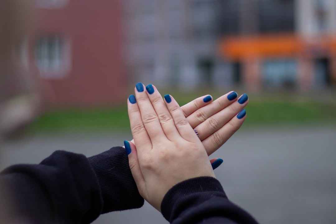 person with blue manicure and blue manicure