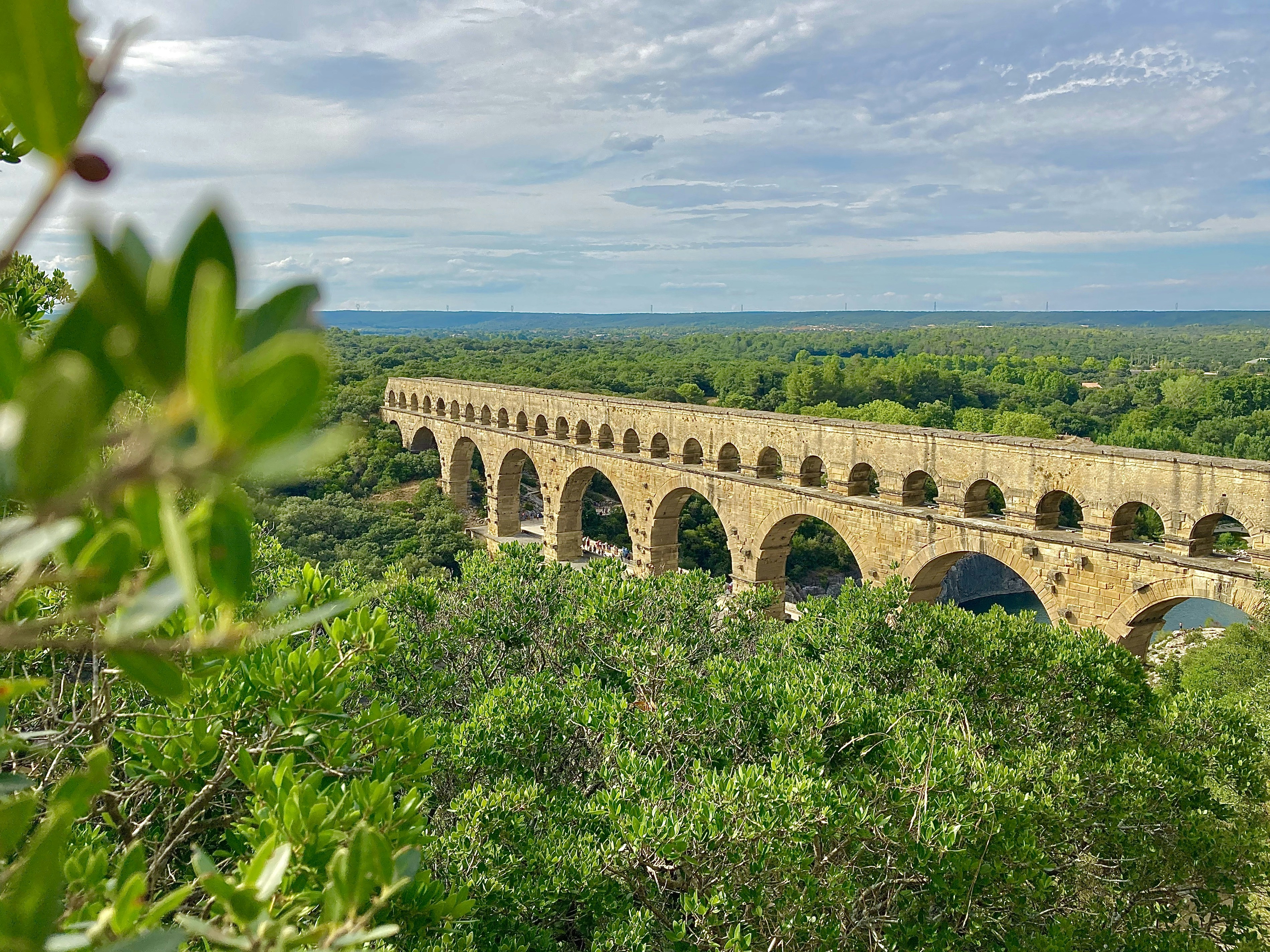 Fig.2: A Roman Bridge in Gard, France. Roman engineering required already some attributes of modern work design, with the division of labour and specialisation. Photo by Sébastien Jermer on Unsplash