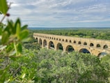 An image of a restored aqueduct in a rural area.