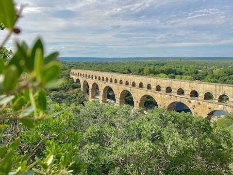An image of a restored aqueduct in a rural area.