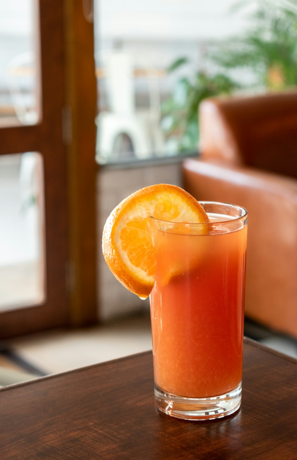 orange juice in clear drinking glass