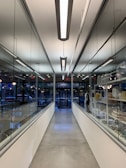 white and blue hallway with lights turned on in a building