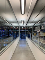 white and blue hallway with lights turned on in a building
