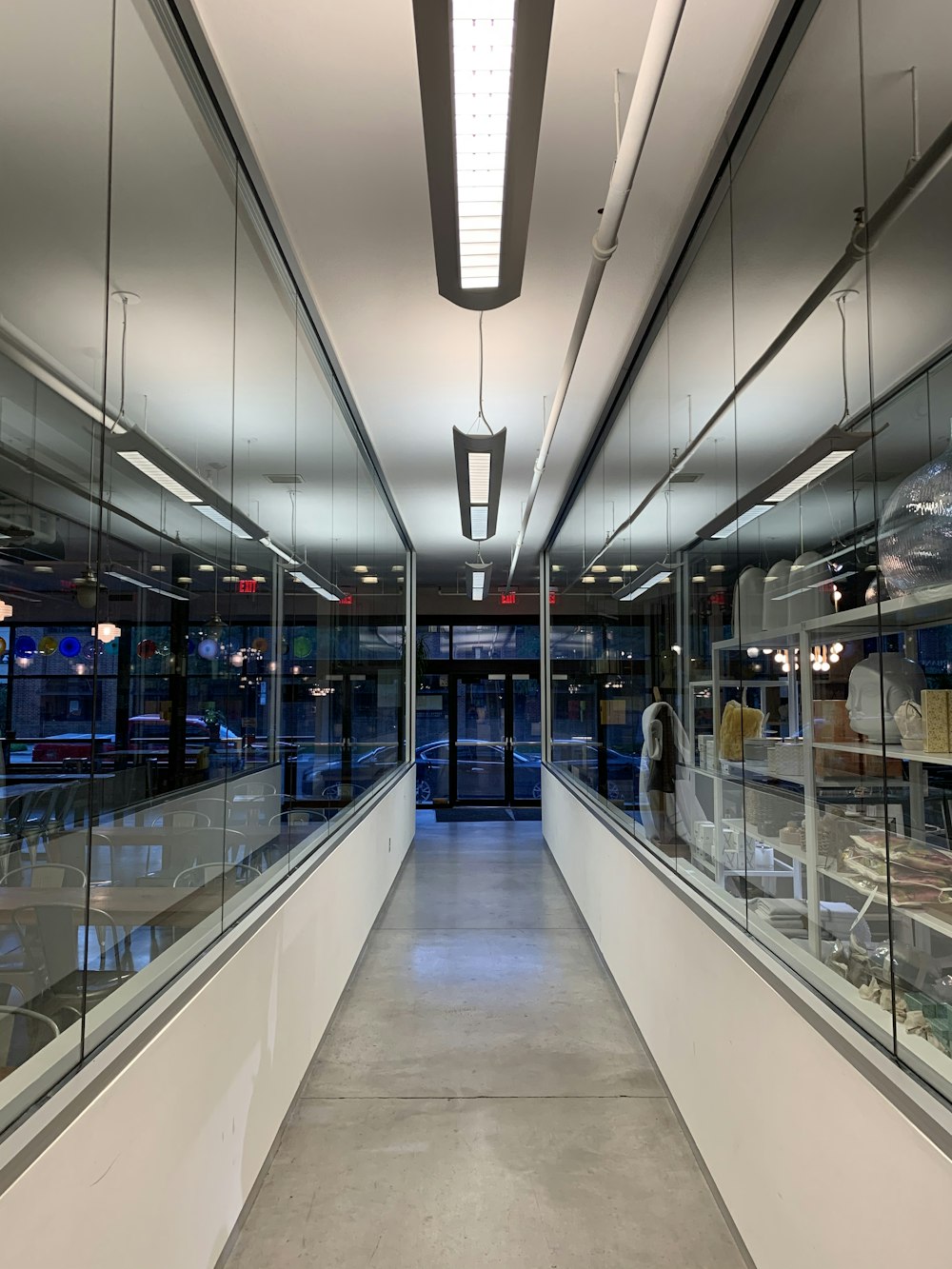 white and blue hallway with lights turned on in a building