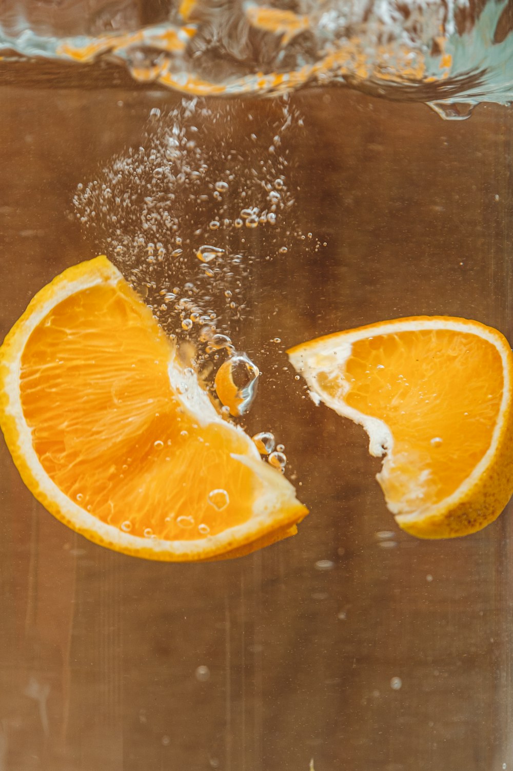 sliced orange fruit on brown wooden table