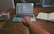 A developer working on a laptop with code on the screen, surrounded by notes and coffee.