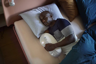 man in black t-shirt lying on bed