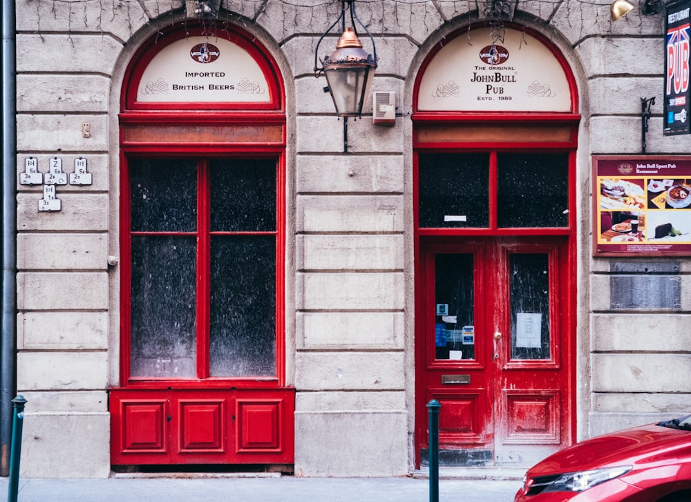 red wooden door on gray concrete building