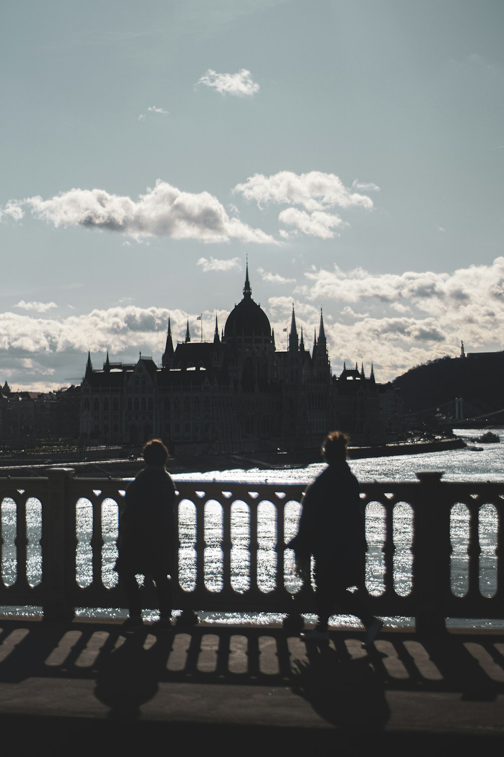 man in black jacket standing on bridge during daytime