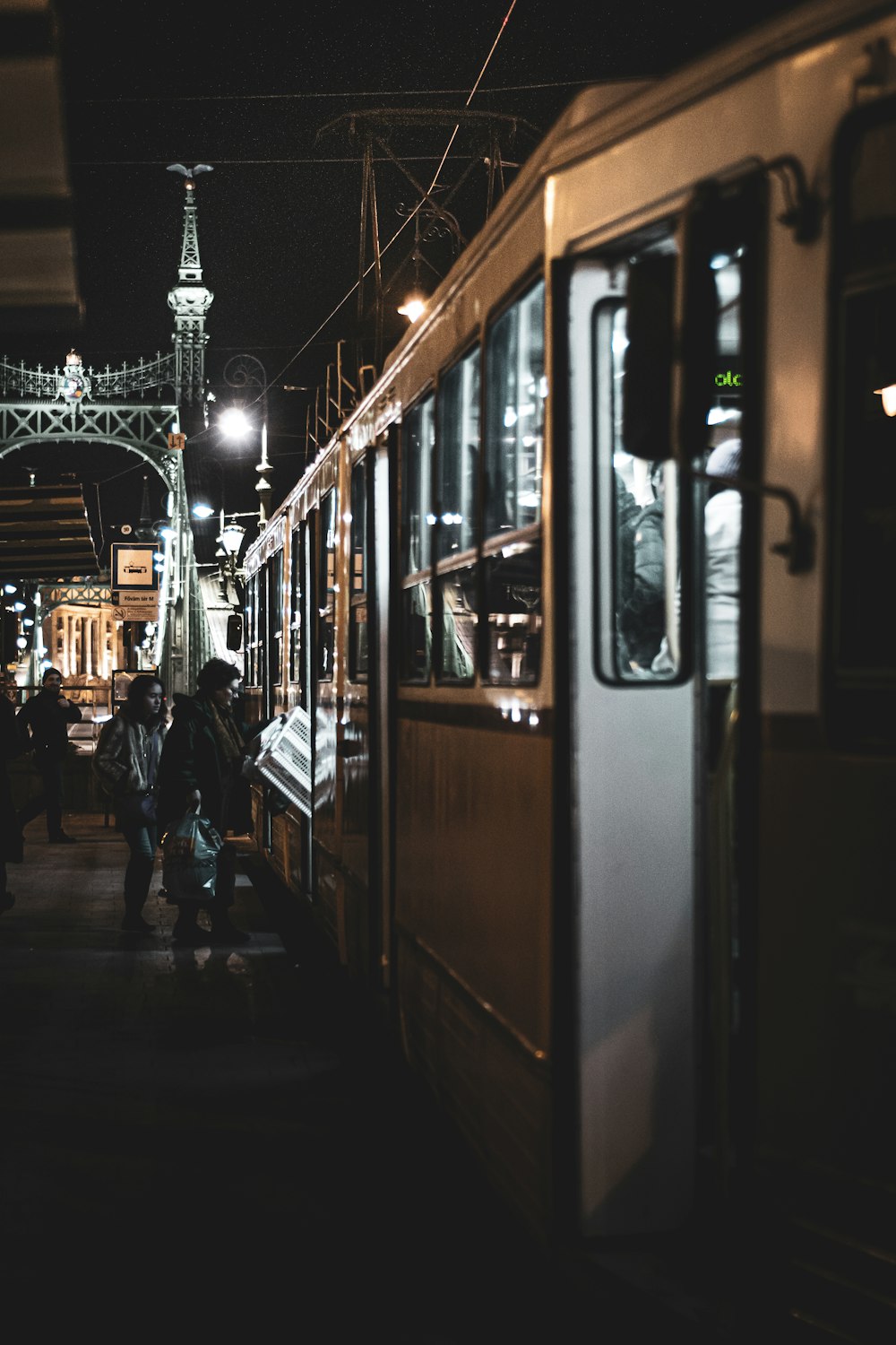 people walking on sidewalk during night time