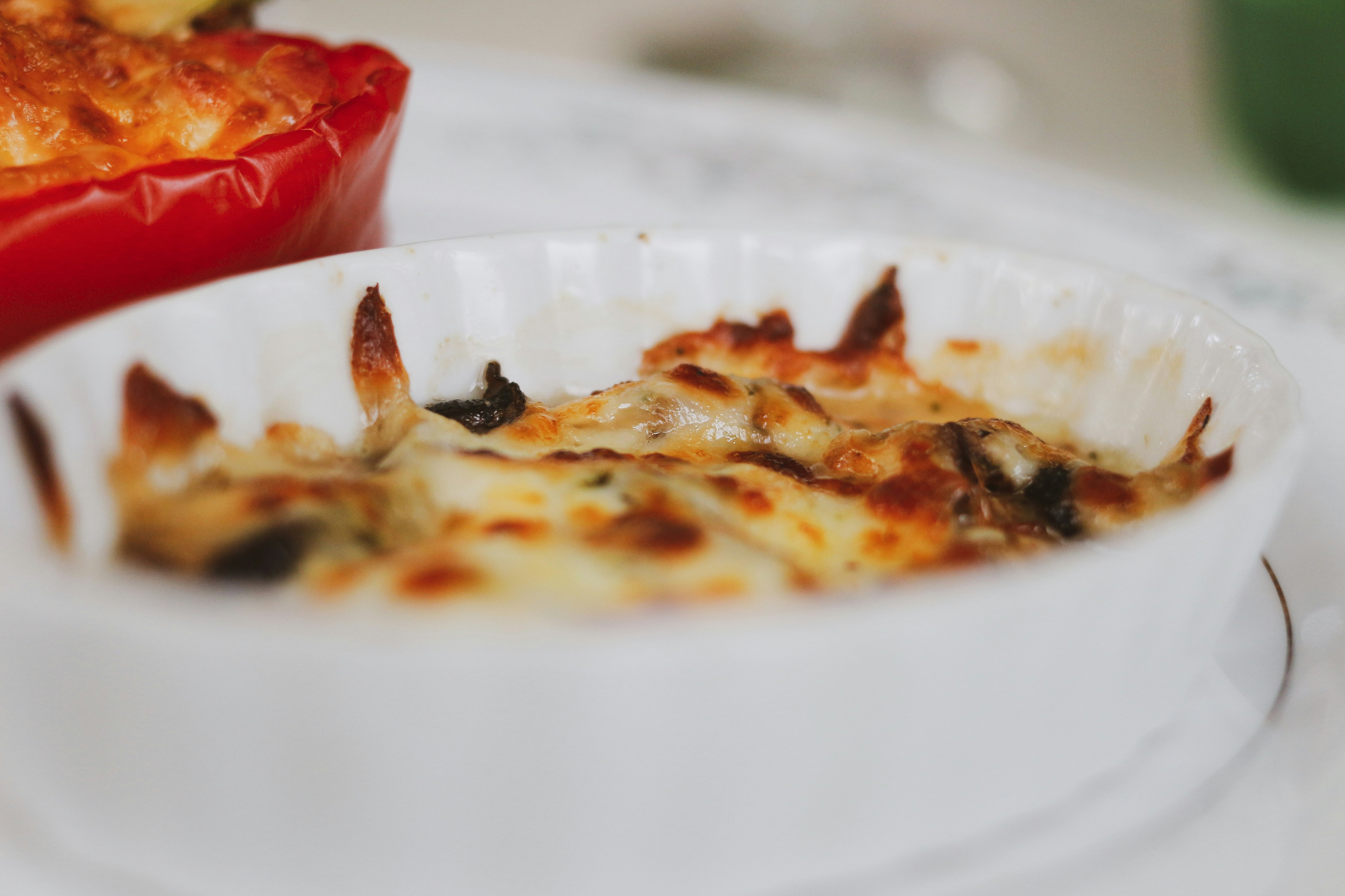 red and brown food on white ceramic plate