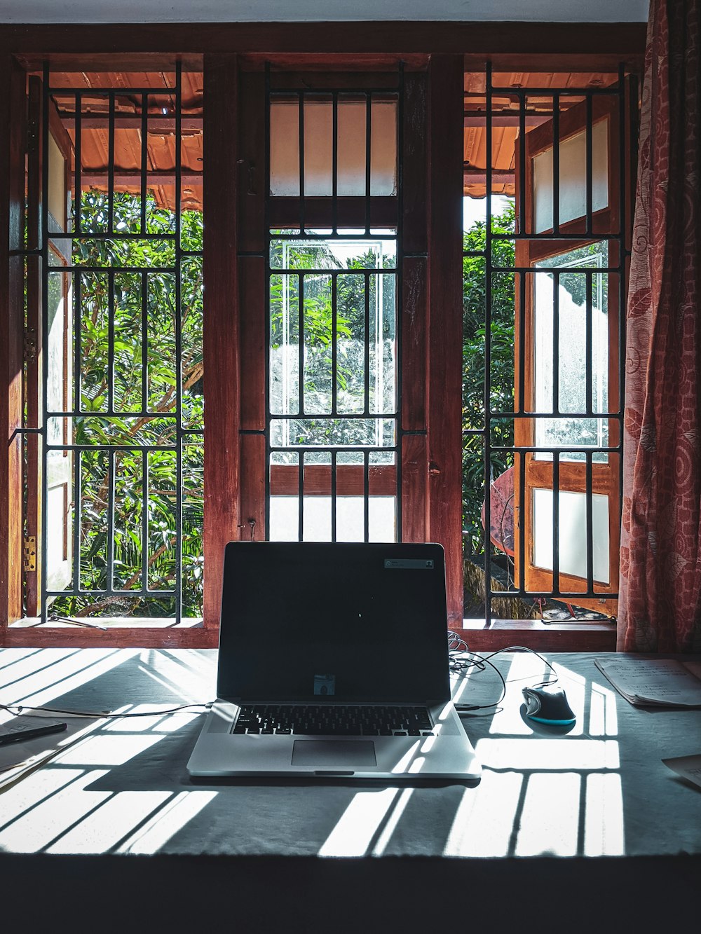 black and gray laptop computer on brown wooden table