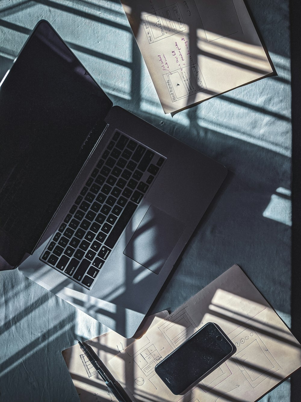 black laptop computer on blue and white textile