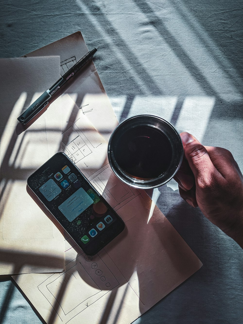 black iphone 4 beside black pen