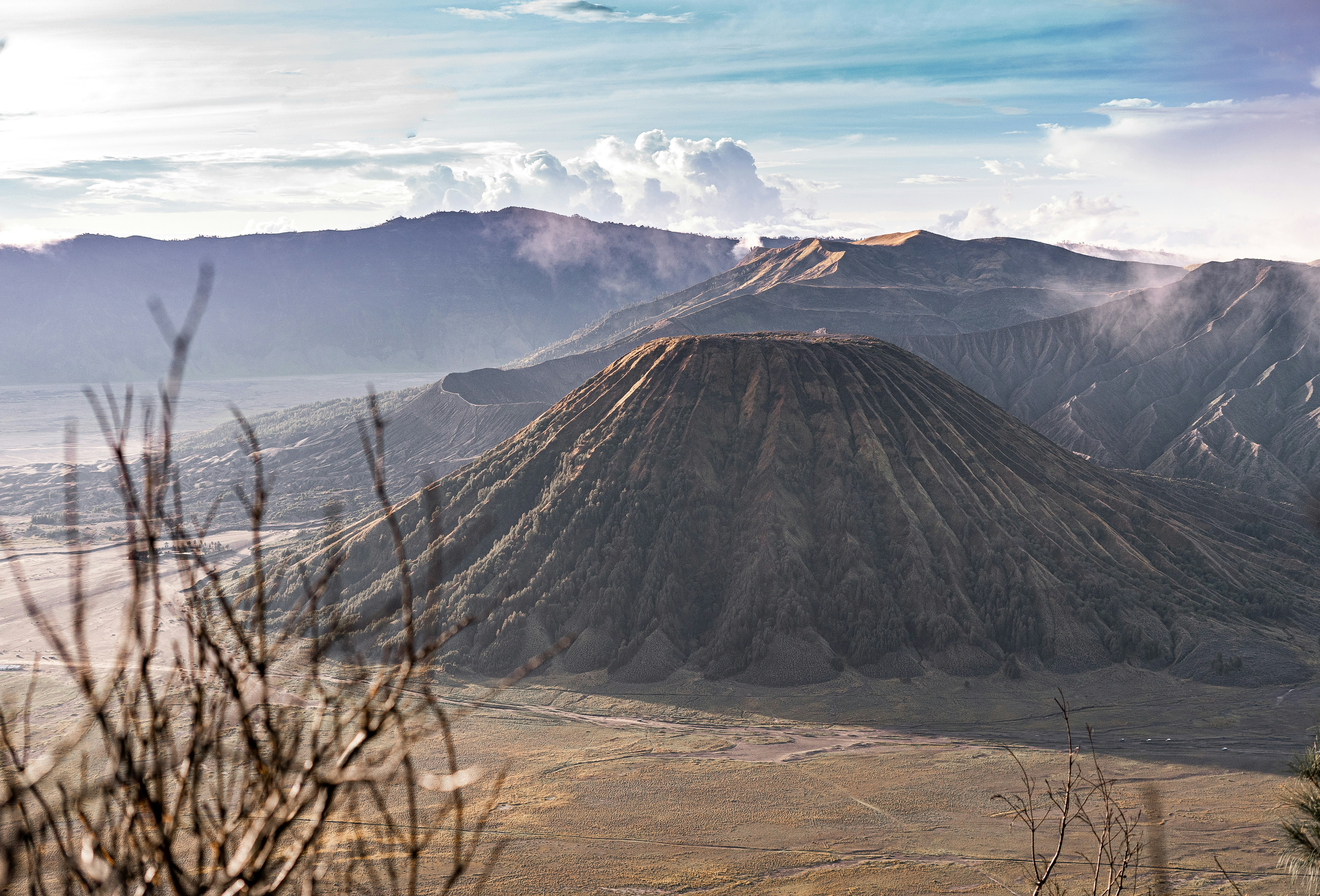brown and black mountain under white clouds during daytime, Having an opportunity to capture the beautiful Bromo Mountain area. Rising sun is the best natural light ever. 