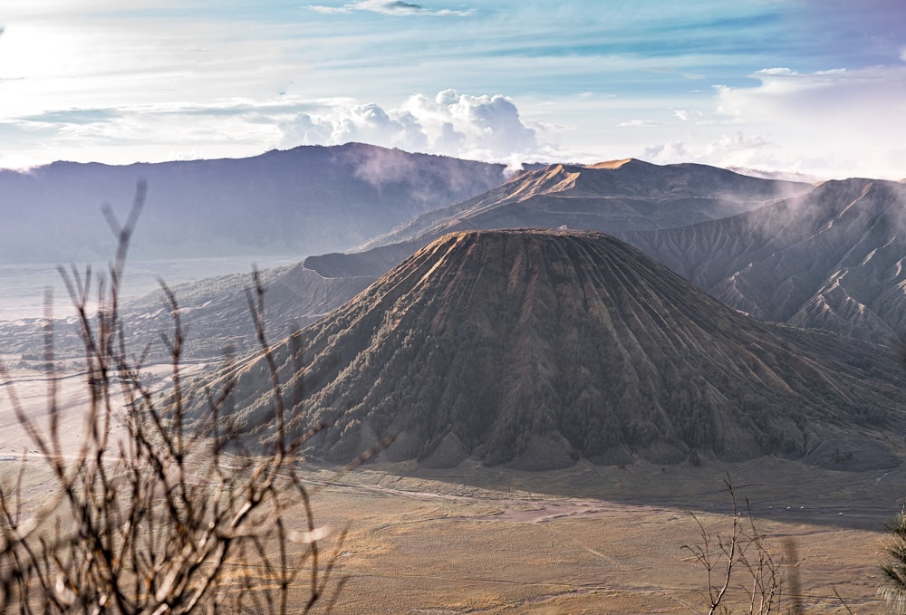 brown and black mountain under white clouds during daytime