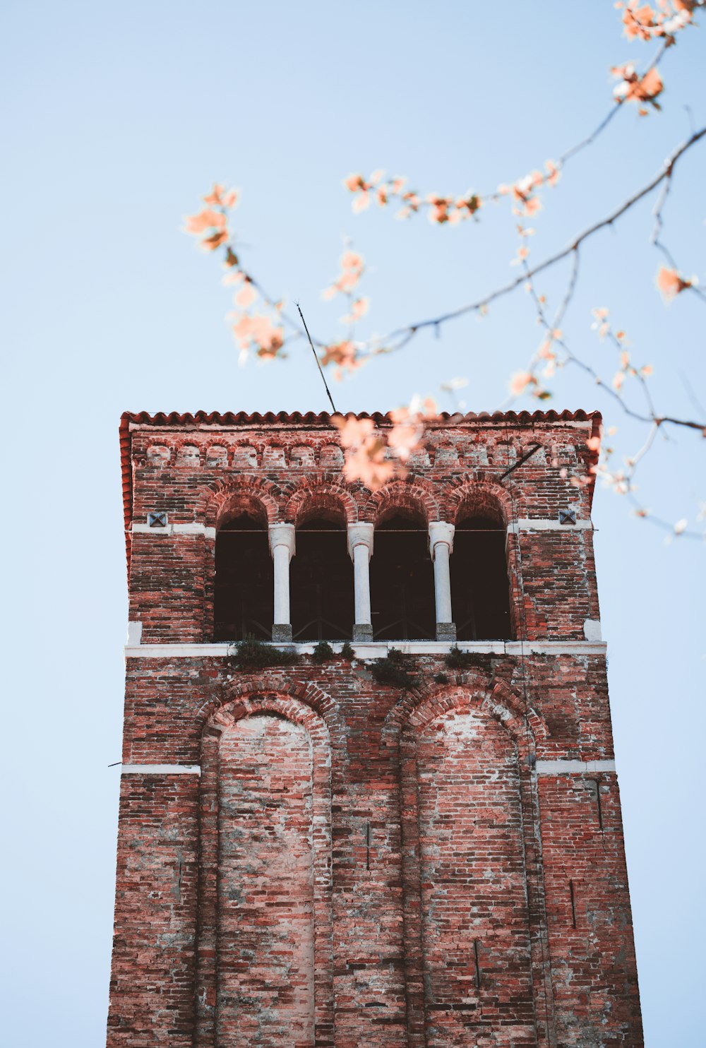 brown brick tower with white string lights