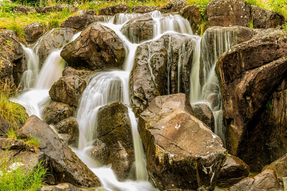 water falls on brown rock