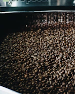 Export crates of premium coffee beans being loaded into a shipping container.