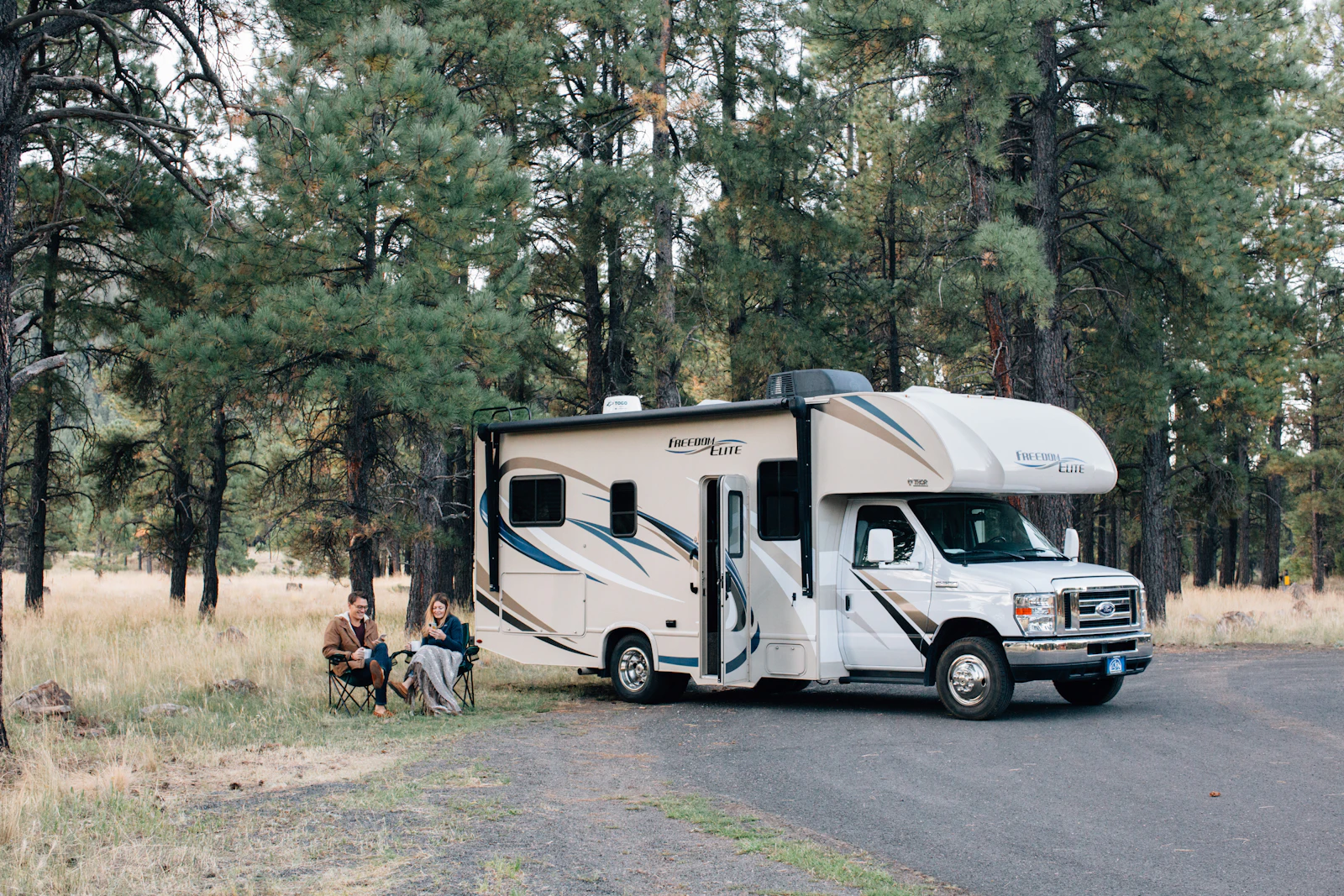 Class C motorhome at a wooded campsite