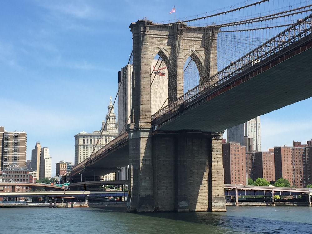 brown concrete bridge under blue sky during daytime