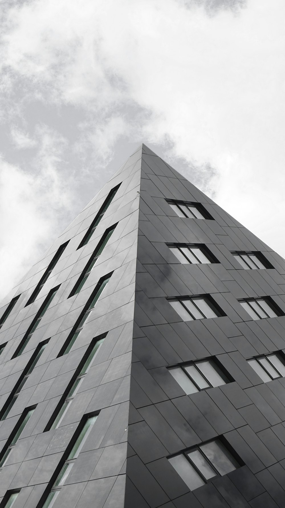 gray concrete building under white clouds during daytime