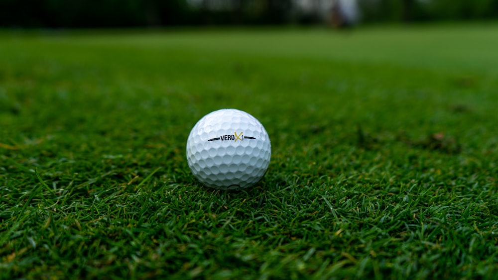 white golf ball on green grass field during daytime