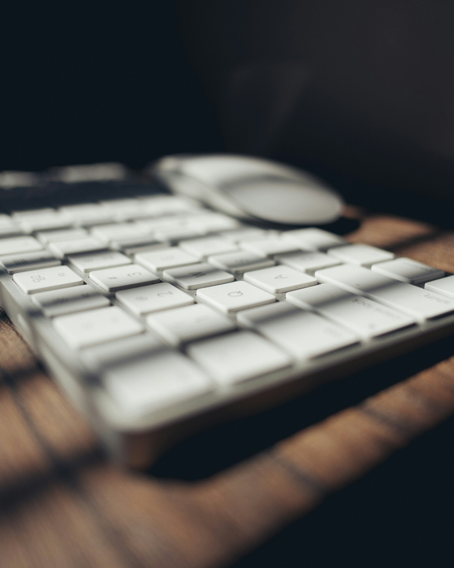 white apple keyboard on brown wooden table