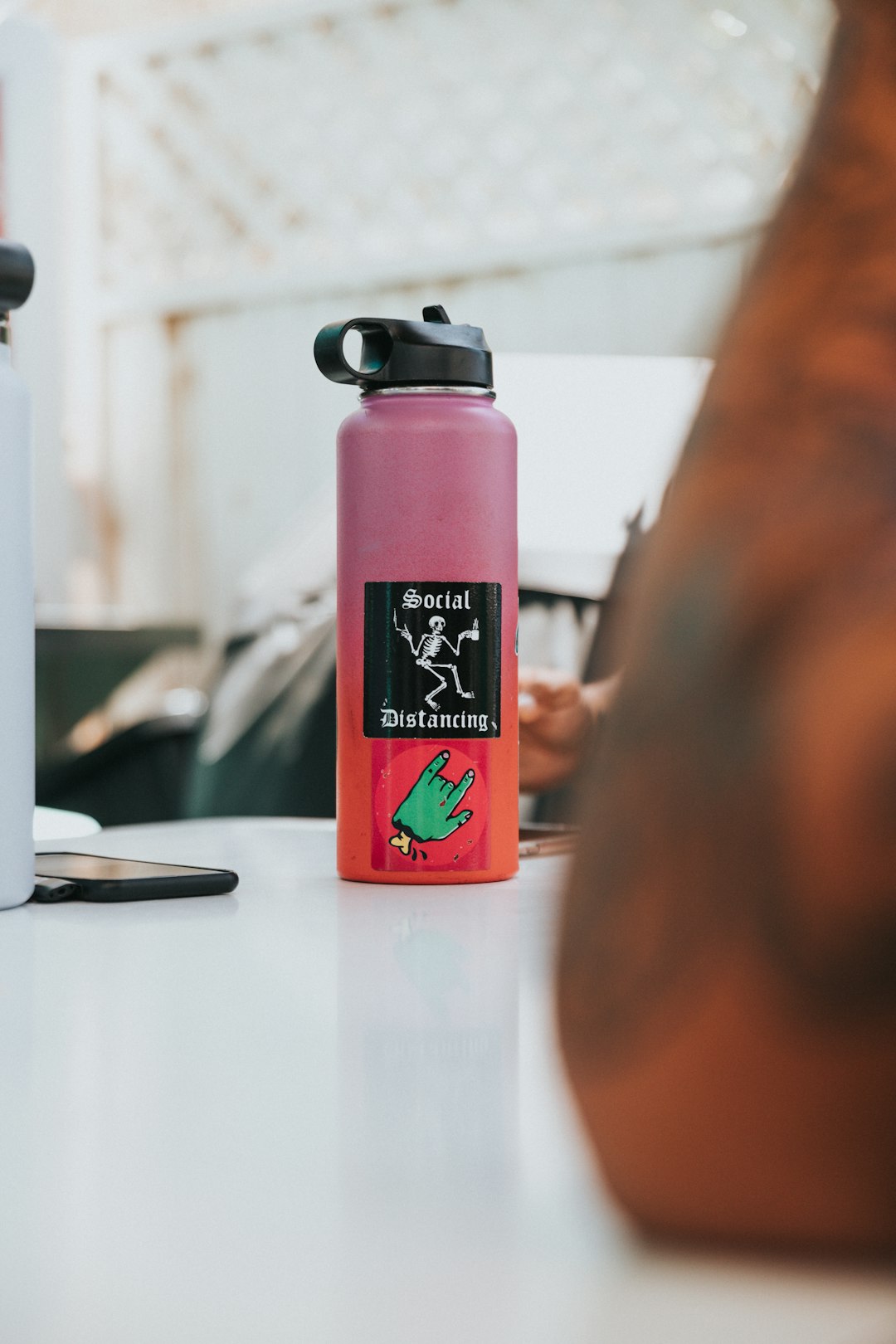 pink and black sports bottle on table