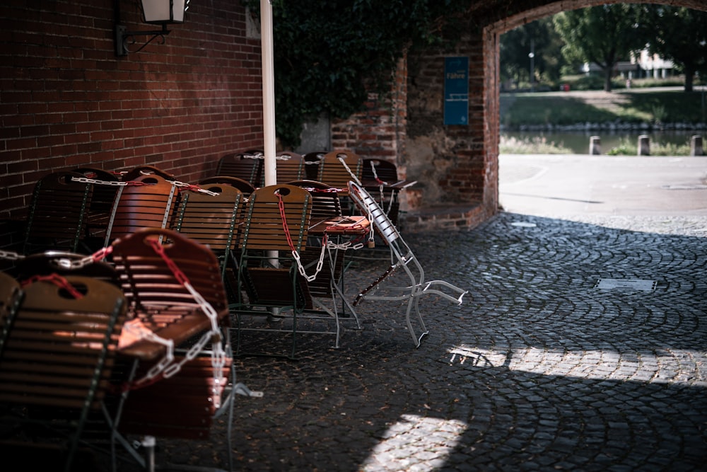 brown wooden chairs and tables near brown brick wall