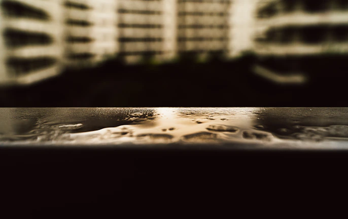 Close-up of a freshly coated wall with Aqua-Shield’s glossy, waterproof surface under bright daylight.