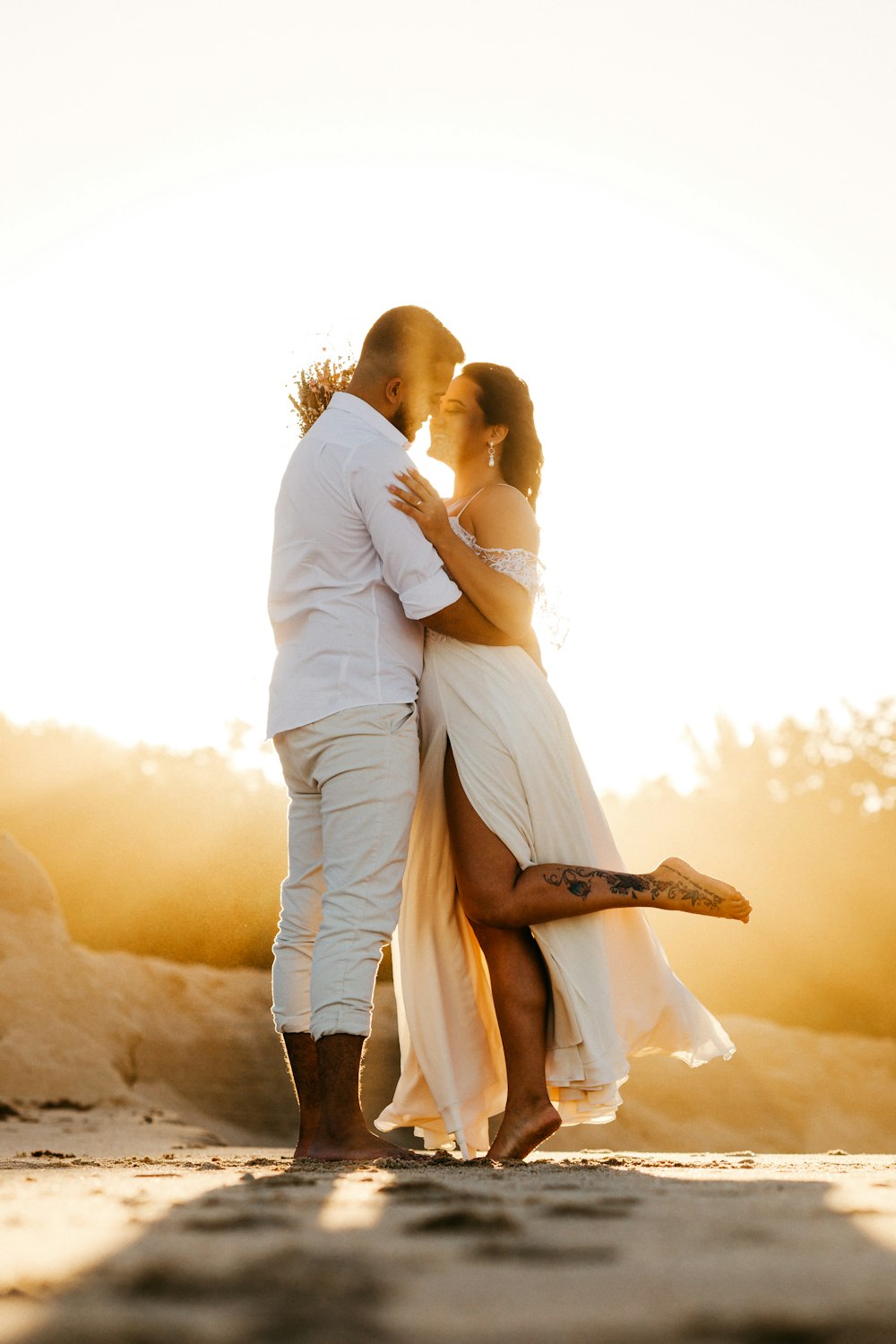 man and woman kissing during sunset