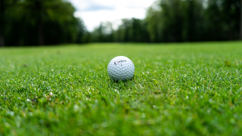 white golf ball on green grass field during daytime