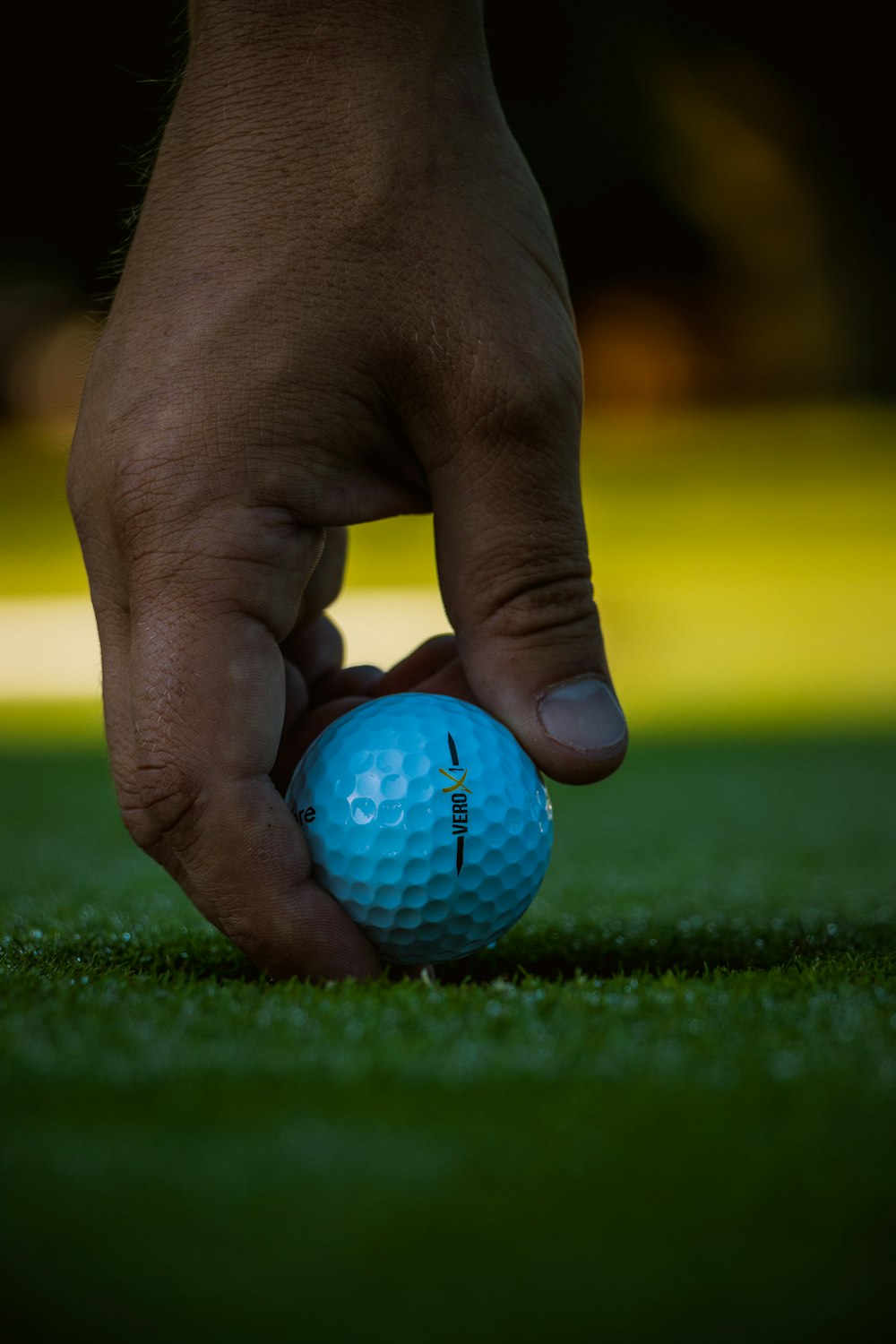 blue golf ball on persons hand