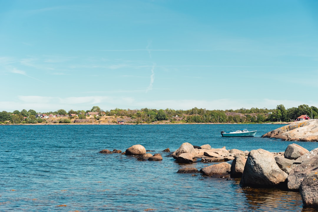 brown rocks on body of water during daytime