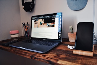 black laptop computer on brown wooden table