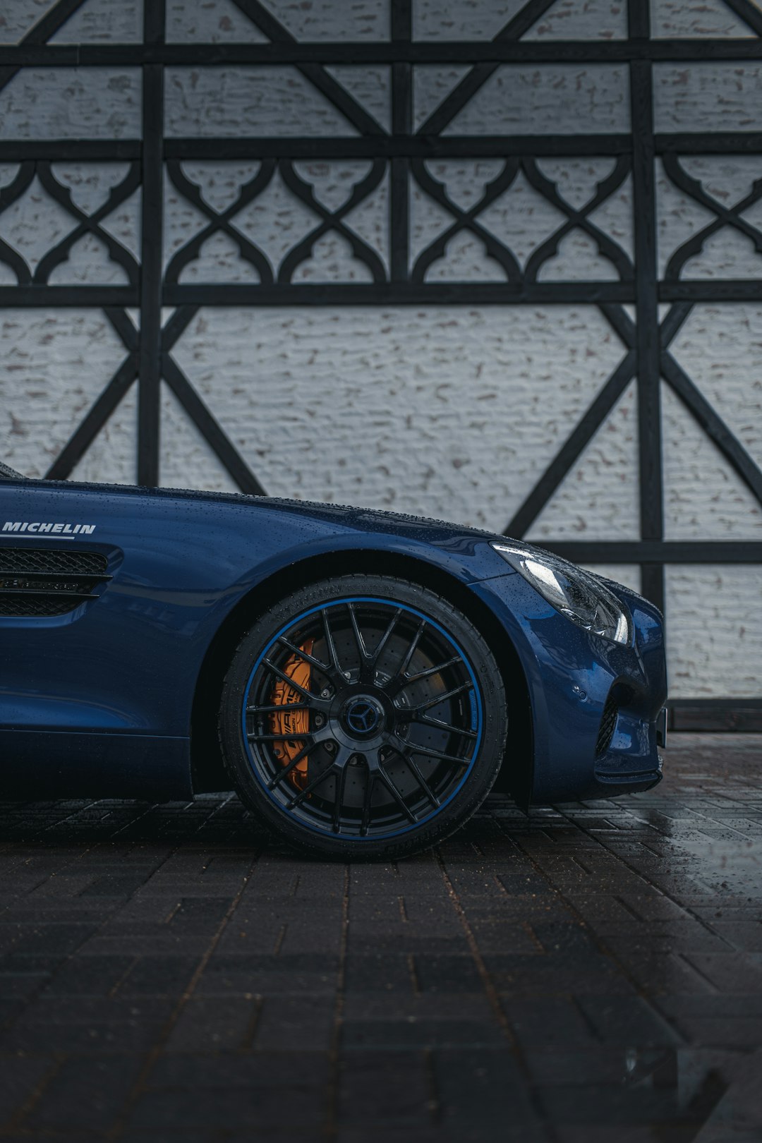 blue porsche 911 parked on white concrete floor