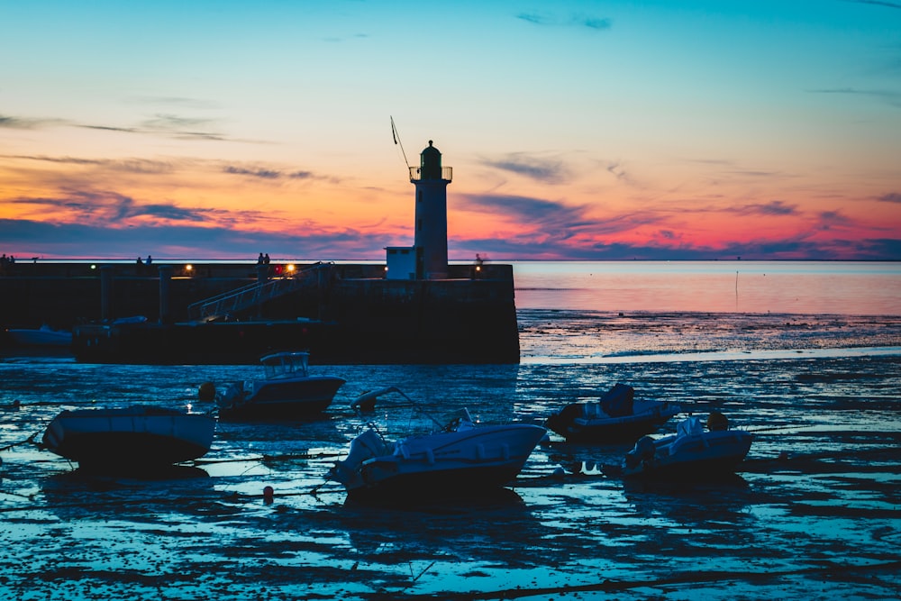 silhouette of boat on sea during sunset