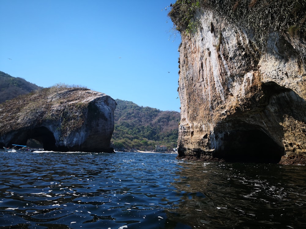 brown rock formation on sea during daytime