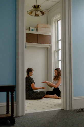 A caring therapist working one-on-one with a young student in a bright, welcoming learning space.