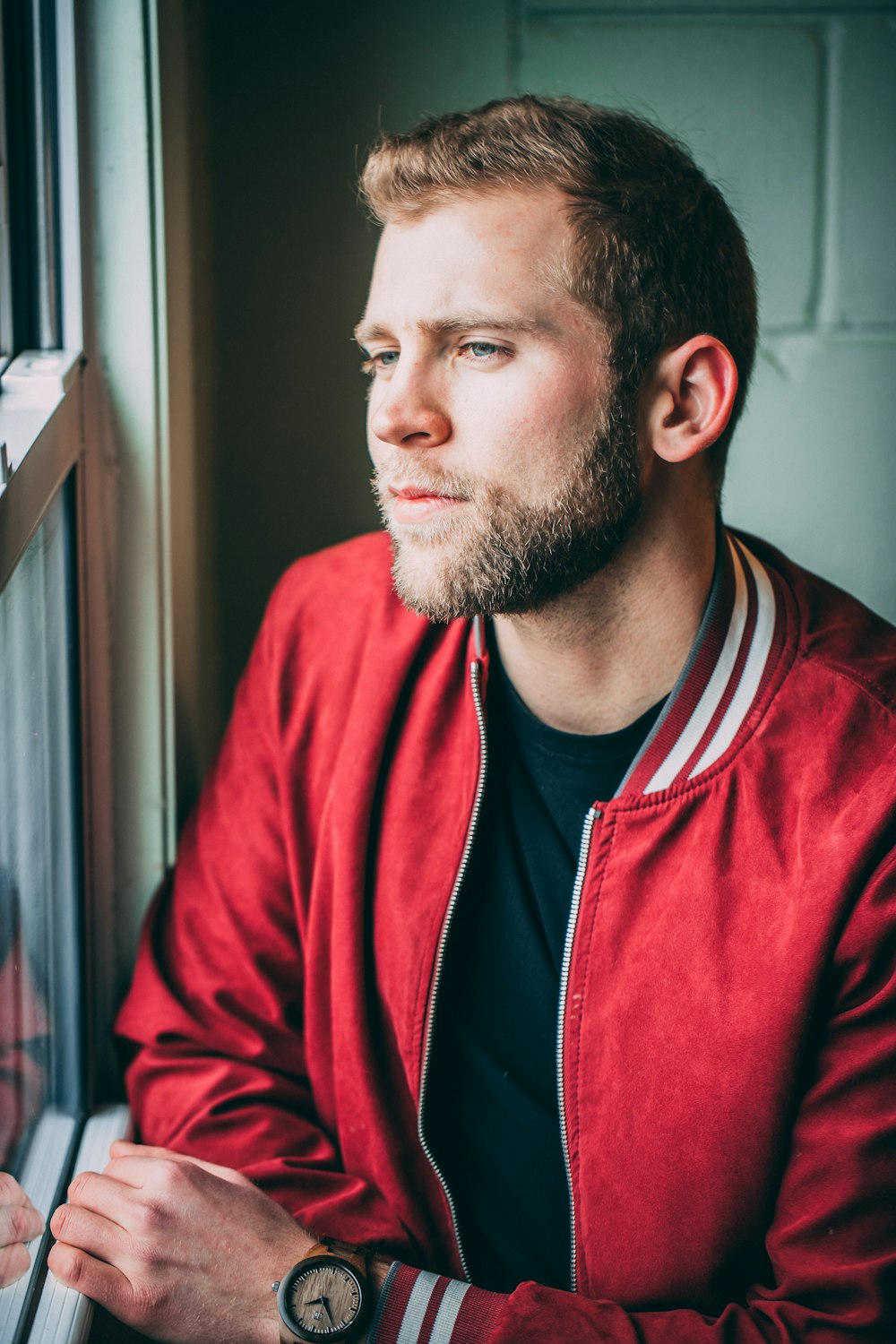 man in red and black zip up jacket