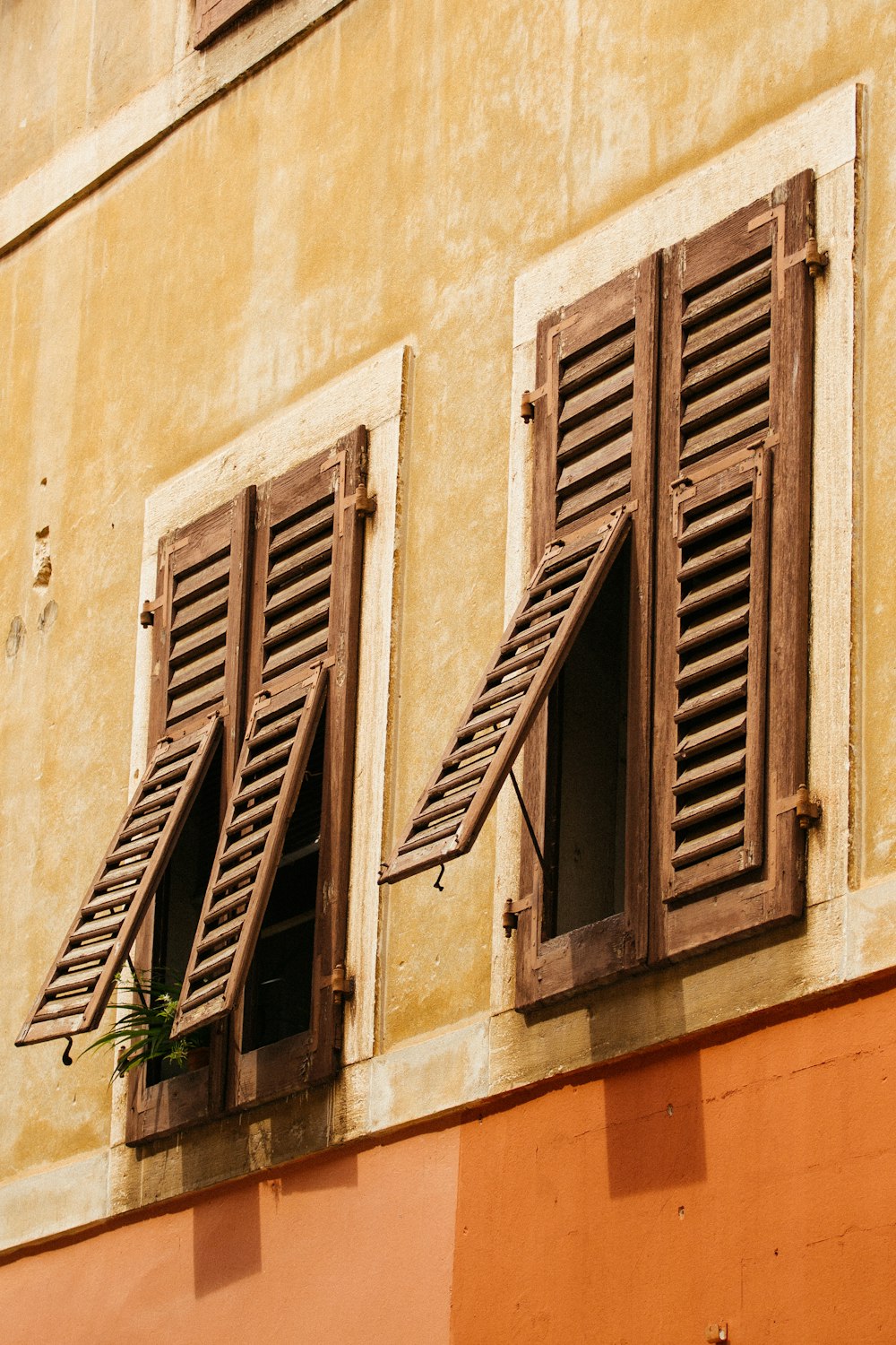brown wooden window on beige concrete wall